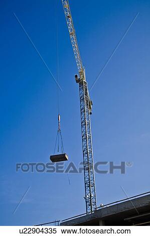 Stock Photography - Crane working on a construction site. Fotosearch