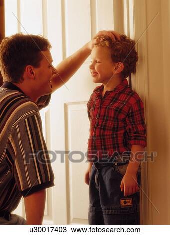 Stock Image - Father and son looking in eyes and smiling. Fotosearch