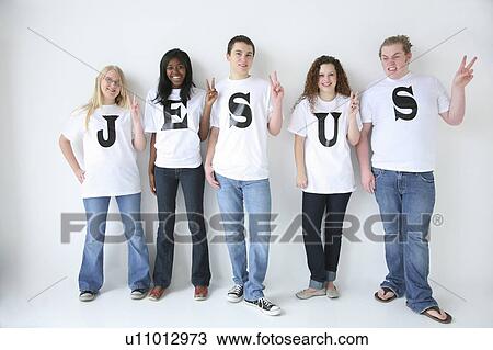 Stock Image - Five teenagers with t-shirts spelling Jesus. Fotosearch
