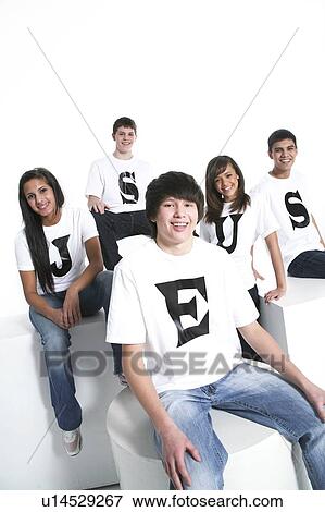 Stock Photo - Five teenagers with t-shirts spelling Jesus. Fotosearch
