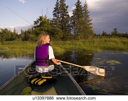 Stock Photograph - Girl canoeing. Fotosearch