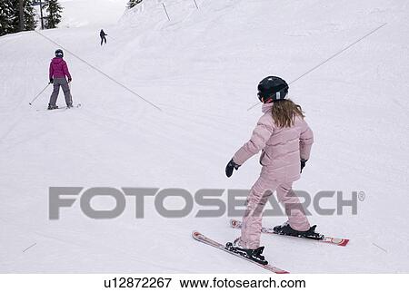 Stock Photo - Girl downhill skiing, Whistler, BC, Canada. Fotosearch