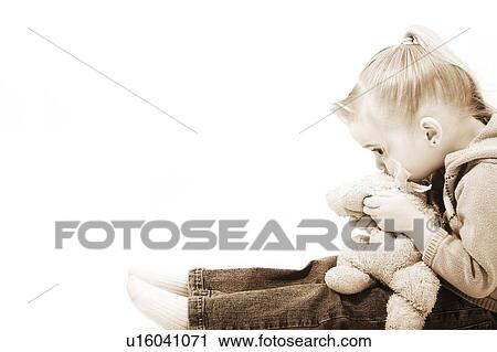 Stock Image - Girl holding her teddy bear. Fotosearch