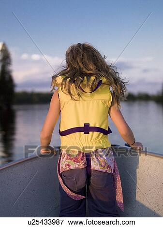 Girl in the front of a boat View Large Photo Image Stock Photo - Girl in the front of a boat. Fotosearch