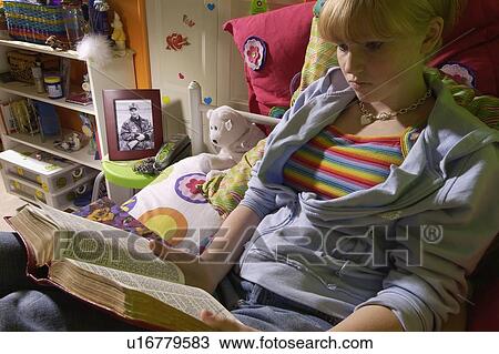 Girl reading Bible in bedroom View Large Photo Image Stock Image - Girl reading Bible in bedroom. Fotosearch