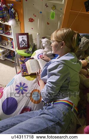 Girl reading Bible in bedroom View Large Photo Image Stock Photo - Girl reading Bible in bedroom. Fotosearch