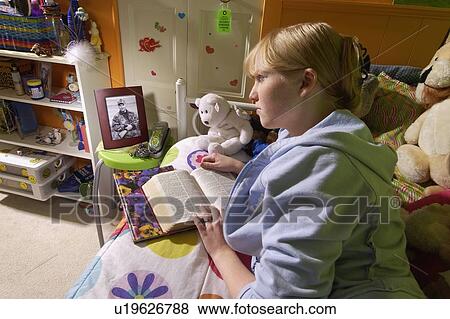 Girl reading Bible in bedroom View Large Photo Image Stock Photo - Girl reading Bible in bedroom. Fotosearch
