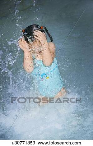 Girl splashing in the water View Large Photo Image Stock Photo - Girl splashing in the water. Fotosearch