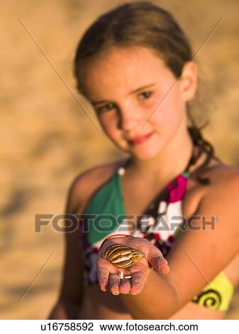 Girl with seashell View Large Photo Image Stock Image - Girl with seashell. Fotosearch