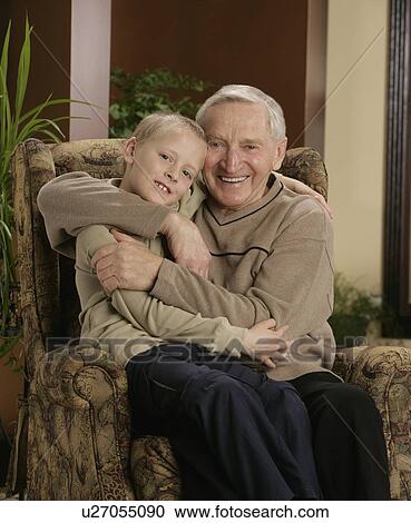 Stock Image - Grandfather hugging grandson. Fotosearch