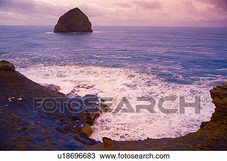 Stock Image - Haystack Rock at sunset at Cape Kiwanda, Oregon, USA. Fotosearch