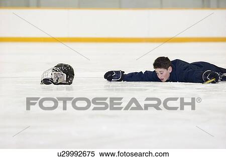 Hockey player who has fallen on the ice View Large Photo Image Stock Photography - Hockey player who has fallen on the ice. Fotosearch