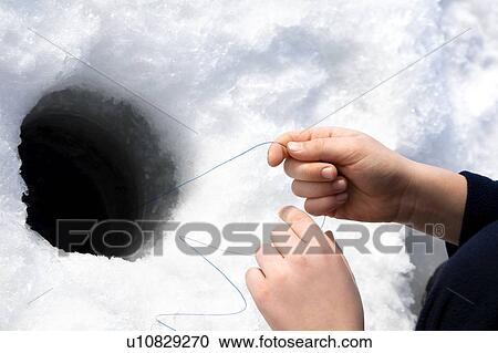 Stock Image - Ice fishing. Fotosearch