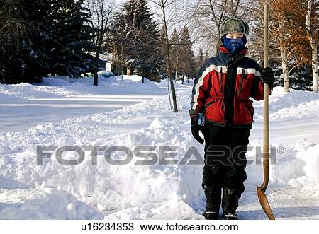 Kid shovelling View Large Photo Image Stock Image - Kid shovelling. Fotosearch