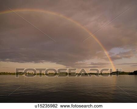 Stock Image - Lake of the woods, Ontario, Canada, Rainbow over the lake. Fotosearch