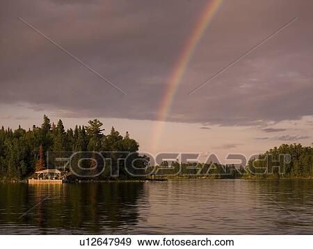 Stock Photo - Lake of the Woods, Ontario, Canada, Rainbow over the lake. Fotosearch