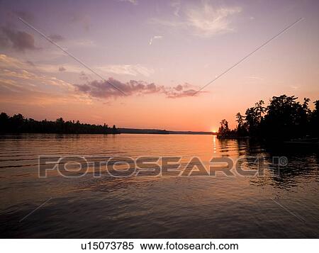 Stock Photography - Lake of the Woods, Ontario, Canada, Sunset at a lake. Fotosearch