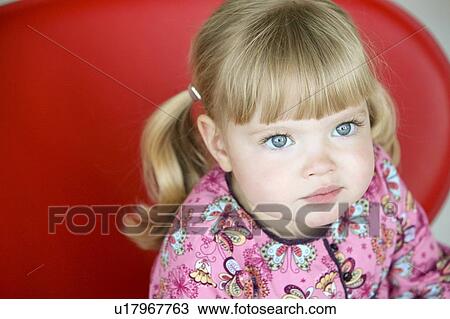 Little girl sitting on a red chair View Large Photo Image Stock Image - Little girl sitting on a red chair. Fotosearch