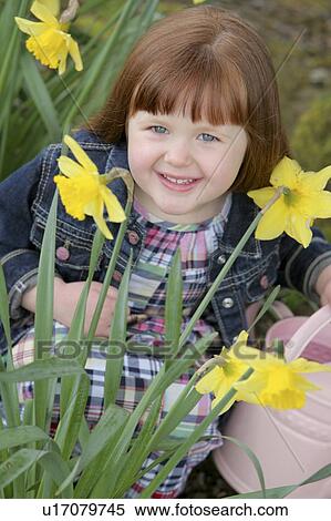 Little girl with daffodils View Large Photo Image Stock Photography - Little girl with daffodils. Fotosearch