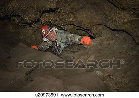 Man crawling in cave, Cadomin, Alberta, Canada View Large Photo Image Stock Image - Man crawling in cave, Cadomin, Alberta, Canada. Fotosearch