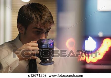 Man drinking a cup of coffee View Large Photo Image Stock Photo - Man drinking a cup of coffee. Fotosearch