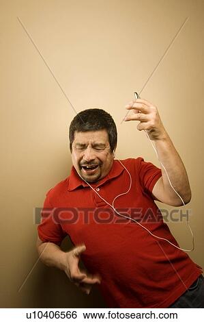 Stock Photograph - Man listening to music player. Fotosearch
