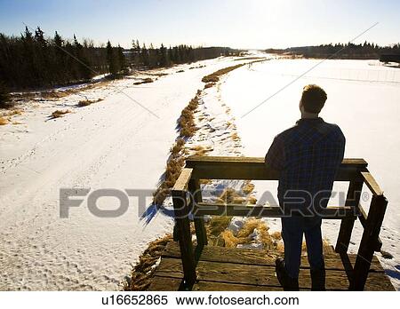 Man looking at landscape from footbridge, rear view View Large Photo Image Stock Photography - Man looking at landscape from footbridge, rear view. Fotosearch