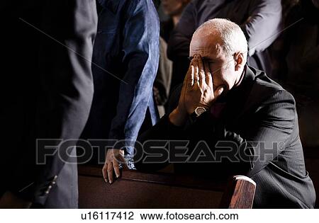 Man praying in a pew View Large Photo Image Stock Image - Man praying in a pew. Fotosearch