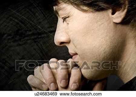 Stock Photo - Man praying. Fotosearch