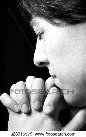 Stock Photo - Man praying. Fotosearch