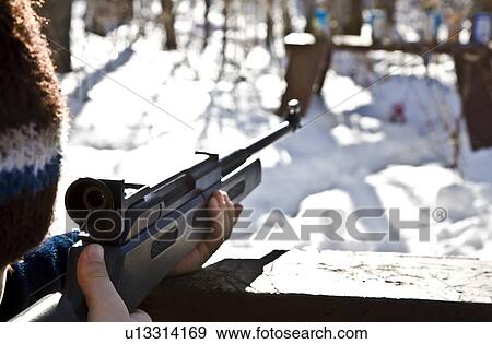 Stock Photo - Man shooting a gun. Fotosearch