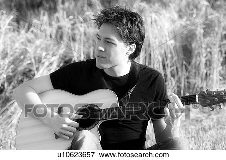 Man with an acoustic guitar View Large Photo Image Stock Photo - Man with an acoustic guitar. Fotosearch