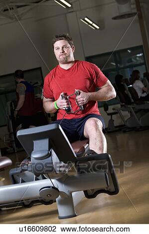 Man working out in a gym View Large Photo Image Stock Image - Man working out in a gym. Fotosearch