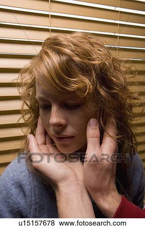 Stock Photo - Man's hands touching a woman's face. Fotosearch