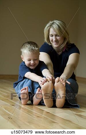 Stock Photo - Mother and son playing on the floor. Fotosearch