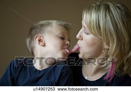 Stock Image - Mother and son sticking tongue out. Fotosearch