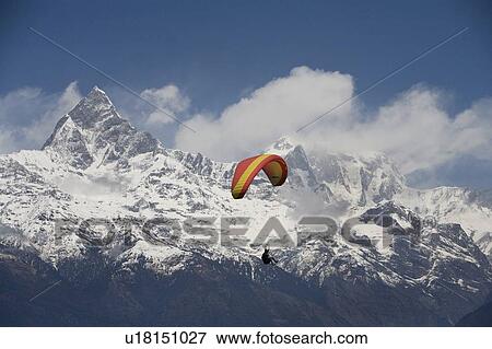Stock Photo - Paragliding, Annapurna region, Himalayas, Pokhara, Nepal. Fotosearch