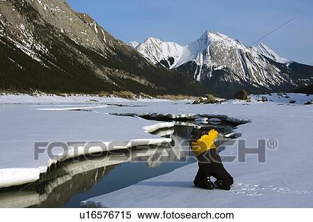 Person on the snow in the Maligne Mountain Range, Alberta, Canada View Large Photo Image Stock Photography - Person on the snow in the Maligne Mountain Range, Alberta, Canada. Fotosearch