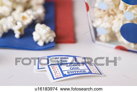 Picture - Popcorn bowl with movie tickets . Fotosearch