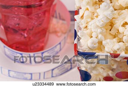 Stock Photo - Popcorn, drink and movie tickets . Fotosearch