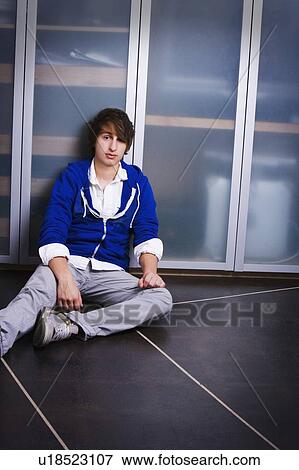 Portrait Of A Teenage Boy Sitting On The Ground View Large Photo Image Stock Photo - Portrait Of A Teenage Boy Sitting On The Ground. Fotosearch