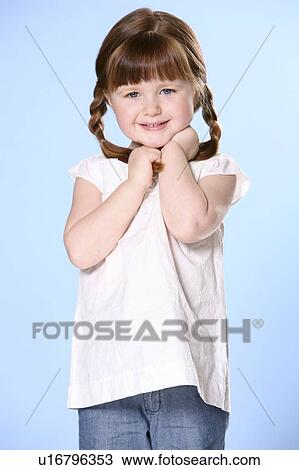 Stock Image - Portrait of little girl with braids. Fotosearch