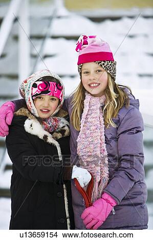 Portrait of two girls in winter clothes View Large Photo Image Picture - Portrait of two girls in winter clothes. Fotosearch
