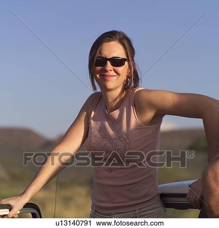 Stock Image - Portrait of woman in the sun. Fotosearch