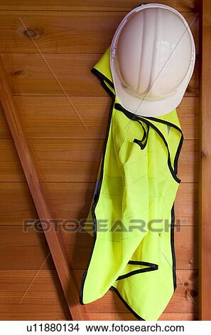 Reflective vest and hardhat hanging up View Large Photo Image Picture - Reflective vest and hardhat hanging up. Fotosearch