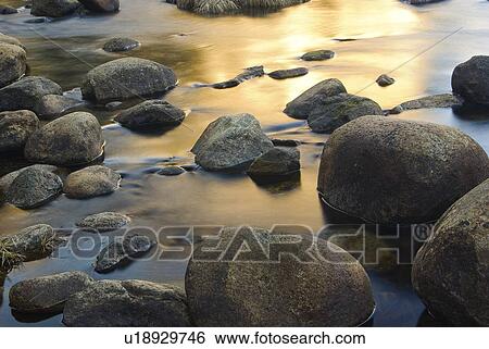 Stock Photograph - Rocks in water. Fotosearch