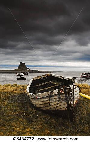 Row boat on the volcanic shore of Beblowe Craig, England View Large Photo Image Stock Image - Row boat on the volcanic shore of Beblowe Craig, England. Fotosearch