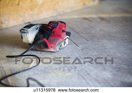 Stock Photo - Sander on the floor. Fotosearch