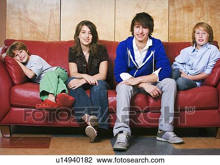 Stock Image - Siblings on a couch. Fotosearch