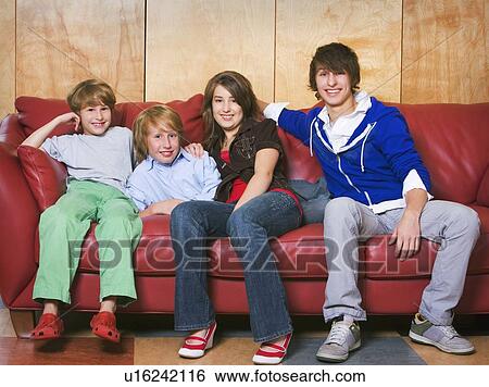 Stock Photograph - Siblings on a couch. Fotosearch